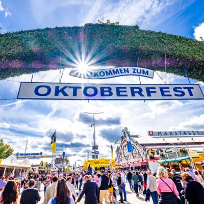 Munich, Germany - September 27: visitors, beertents and fairground rides on the oktoberfest in munich at September 27, 2019